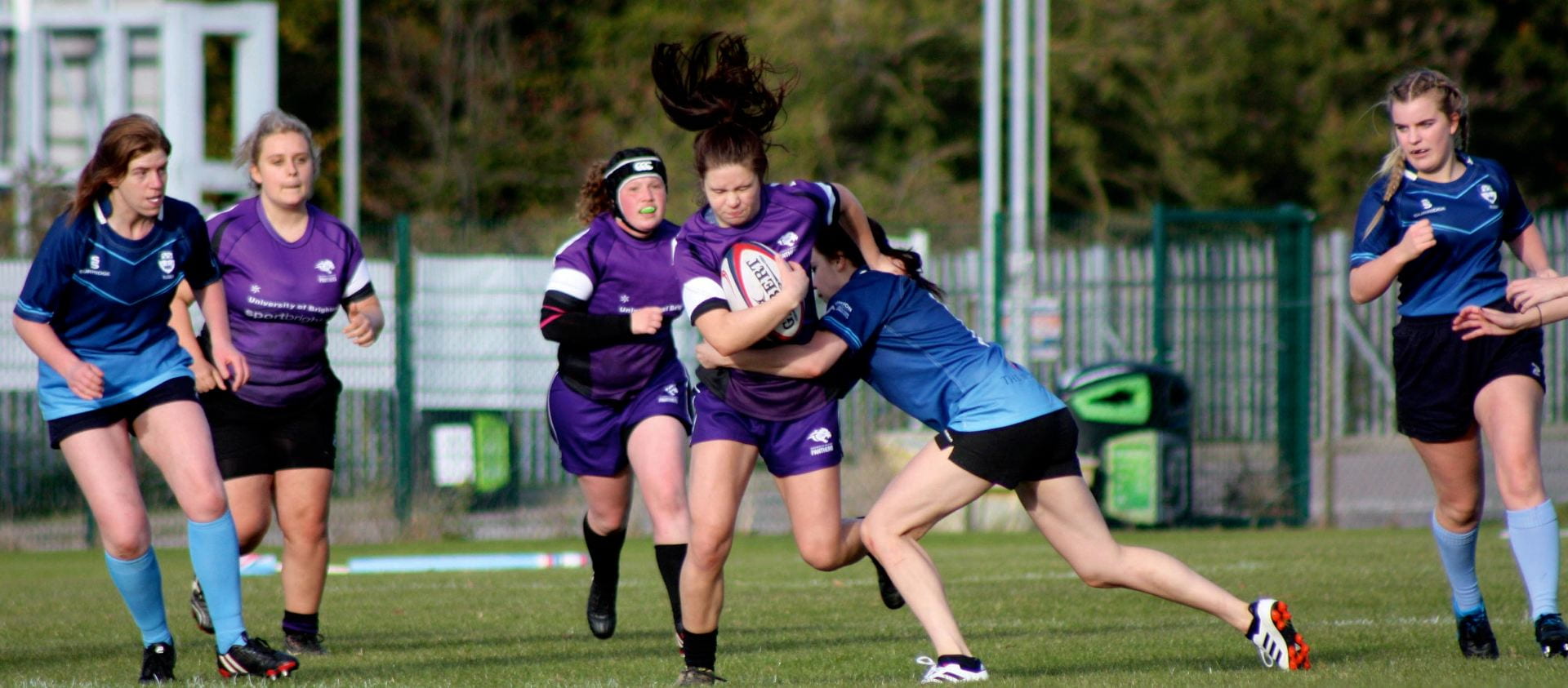 Women playing rugby.