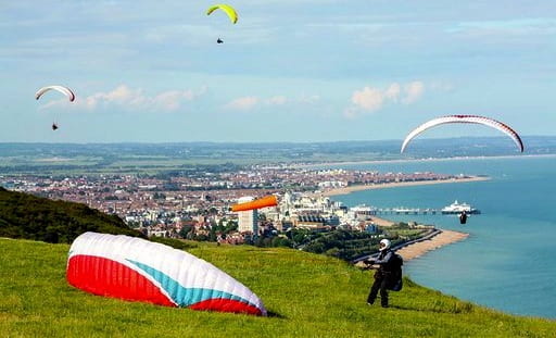 Paragliders enjoying the beautifull weather high over Beachy Head and Eastbourne in East Sussex.